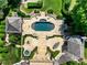 Aerial view of backyard with pool, hot tub, patio, and dining area surrounded by lush landscaping at 266 Perfect Moment Dr, Durham, NC 27713