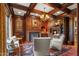 A refined wood-paneled study with fireplace, coffered ceiling, and custom shelving at 266 Perfect Moment Dr, Durham, NC 27713
