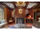 Wood-paneled study with fireplace, coffered ceiling, and custom built-ins at 266 Perfect Moment Dr, Durham, NC 27713