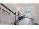 Inviting foyer with hardwood floors, staircase, decor table, mirror, and a view of the front door at 266 Sweetbay Tree Dr, Wendell, NC 27591