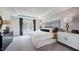 Well-lit main bedroom with decorative wallpaper, tray ceiling, and plush carpeting at 266 Sweetbay Tree Dr, Wendell, NC 27591