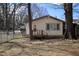 Backyard view featuring a single story house with a wooden porch, and a tree at 309 Cody St, Durham, NC 27703