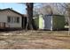 The backyard features a storage shed, a neighboring house, and mature shade trees at 309 Cody St, Durham, NC 27703