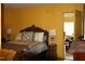 Bedroom featuring decorative bedding, side tables, and a lamp, with a small room view at 309 Cody St, Durham, NC 27703