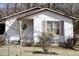 Charming home featuring a cozy front porch and a fenced yard, offering a blend of comfort and security at 309 Cody St, Durham, NC 27703