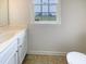 Bathroom with a single vanity, neutral-toned flooring, and a window offering natural light at 4 Birkdale Ct, Durham, NC 27713