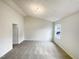 Bright carpeted bedroom with a vaulted ceiling, featuring fresh, neutral-colored walls and natural light at 4 Birkdale Ct, Durham, NC 27713