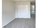 A spacious bedroom showcasing plush carpeting, a double closet, and a view into other rooms at 4 Birkdale Ct, Durham, NC 27713