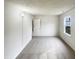 A bright, carpeted bedroom with a textured ceiling, featuring fresh, neutral-colored walls and natural light at 4 Birkdale Ct, Durham, NC 27713