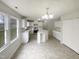 Bright, all-white eat-in kitchen with stainless steel appliances and central island with extra cabinet space at 4 Birkdale Ct, Durham, NC 27713