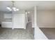 Open living room with neutral-toned flooring and paint, white cabinets, and view to the main entrance at 4 Birkdale Ct, Durham, NC 27713