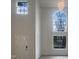 An open living room with soaring ceilings, multiple large windows providing natural light, and chandelier at 4 Birkdale Ct, Durham, NC 27713