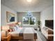 A well-lit main bedroom featuring a large window, comfortable bed, and modern furnishings at 4 Birkdale Ct, Durham, NC 27713