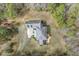 Aerial view showcasing the roof and layout of a charming home with a deck and a large patio at 419 Eagle Point Rd, Pittsboro, NC 27312