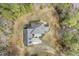 Aerial view displaying a home with deck, patio, well-maintained lawn, and tree-lined property at 419 Eagle Point Rd, Pittsboro, NC 27312