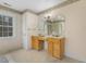Bathroom featuring double sinks with vanities, mirrors and separate shower at 419 Eagle Point Rd, Pittsboro, NC 27312