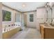 Bathroom featuring a soaking tub, shower, and dual vanities, providing convenience and style at 419 Eagle Point Rd, Pittsboro, NC 27312