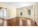 Bedroom features hardwood floors, neutral walls, multiple windows for natural light, and doorway to another room at 419 Eagle Point Rd, Pittsboro, NC 27312