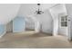 Open bonus room with sloped ceilings, chandelier, and abundant natural light at 419 Eagle Point Rd, Pittsboro, NC 27312