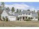Stately two-story home featuring a red front door, second story balcony, and attached two-car garage at 419 Eagle Point Rd, Pittsboro, NC 27312