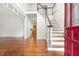 Entryway featuring hardwood floors, staircase, and view into the nearby kitchen area at 419 Eagle Point Rd, Pittsboro, NC 27312
