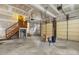 Spacious unfinished two-car garage featuring high ceilings and side access door at 419 Eagle Point Rd, Pittsboro, NC 27312