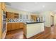 Traditional eat-in kitchen features wood cabinets, tile backsplash, stainless steel appliances, and beautiful hardwood floors at 419 Eagle Point Rd, Pittsboro, NC 27312