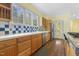 Kitchen featuring stainless steel appliances, natural wood cabinetry, and hardwood floors at 419 Eagle Point Rd, Pittsboro, NC 27312