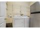 Functional laundry area equipped with washer, dryer, storage shelving, and utility sink at 419 Eagle Point Rd, Pittsboro, NC 27312