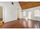 Living room with a wood paneled vaulted ceiling, hardwood floors, and access to the backyard at 419 Eagle Point Rd, Pittsboro, NC 27312