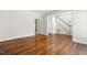 Living room features hardwood floors, staircase, neutral walls, and doorway to another room at 419 Eagle Point Rd, Pittsboro, NC 27312