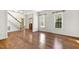 Living room features hardwood floors, staircase, neutral walls, and multiple windows for natural light at 419 Eagle Point Rd, Pittsboro, NC 27312