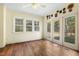 Bright living room featuring multiple windows for natural light and glass doors to the backyard at 419 Eagle Point Rd, Pittsboro, NC 27312