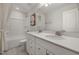 Modern bathroom featuring a double sink vanity with quartz countertops, a bathtub with shower, and elegant finishes at 424 Providence Springs Ln, Fuquay Varina, NC 27526