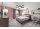 Stylish bedroom with a unique ferris wheel accent wall, a cozy bed with decorative pillows, and a charming desk area at 424 Providence Springs Ln, Fuquay Varina, NC 27526