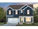 Charming two-story home with a dark blue facade, white trim, and a two-car garage at 424 Providence Springs Ln, Fuquay Varina, NC 27526