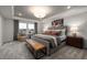 Inviting main bedroom with tray ceiling, large windows, neutral decor, and a comfortable seating area at 424 Providence Springs Ln, Fuquay Varina, NC 27526