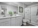 Modern bathroom with double vanity, framed mirror, and glass-enclosed shower at 428 Autumn Moon Dr, Zebulon, NC 27597