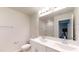 Bathroom featuring a double vanity with large mirror, and a view of the tub at 46 Coffee Tree Cir, Clayton, NC 27527