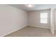 Bedroom features neutral walls, plush carpeting, and natural light at 46 Coffee Tree Cir, Clayton, NC 27527