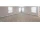 Bright, spacious bedroom with neutral carpeting and three windows offering plenty of natural light at 46 Coffee Tree Cir, Clayton, NC 27527