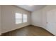 Bright bedroom with wood floors, two windows with blinds, neutral walls, and closet access at 46 Coffee Tree Cir, Clayton, NC 27527