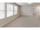 Bright bonus room features neutral walls, plush carpeting, and plenty of windows at 46 Coffee Tree Cir, Clayton, NC 27527