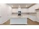 Modern kitchen features white cabinets, stainless steel appliances, granite countertops and a center island with a sink at 46 Coffee Tree Cir, Clayton, NC 27527