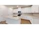 Modern kitchen features white cabinets, stainless steel appliances, granite countertops and a center island with a sink at 46 Coffee Tree Cir, Clayton, NC 27527