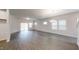 Spacious living area with hardwood floors, recessed lighting, a chandelier, and multiple windows at 46 Coffee Tree Cir, Clayton, NC 27527