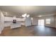 Open-concept living space featuring hardwood floors, recessed lighting, a chandelier, and kitchen with modern appliances at 46 Coffee Tree Cir, Clayton, NC 27527