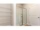 Bathroom featuring a glass door shower, wire shelving and a separate toilet room at 504 Rhino Bnd, Oxford, NC 27565