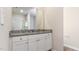 Bathroom vanity with white cabinets, granite countertop and a large mirror at 504 Rhino Bnd, Oxford, NC 27565