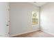 Bedroom with light-colored walls, carpet, and a window view of greenery at 504 Rhino Bnd, Oxford, NC 27565